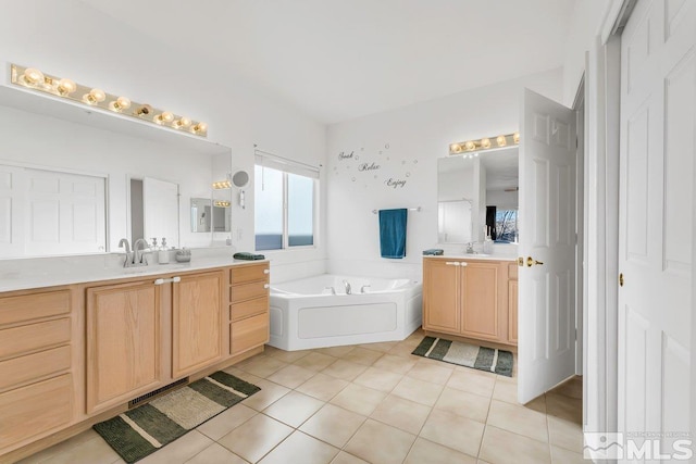 bathroom with vanity, tile patterned floors, and a bathtub