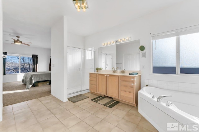 bathroom with a healthy amount of sunlight, tile patterned floors, and vanity