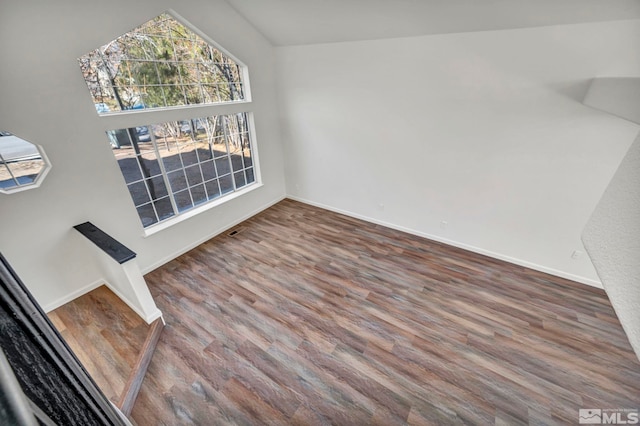 unfurnished dining area featuring dark hardwood / wood-style floors