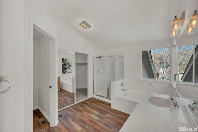 bathroom featuring lofted ceiling, hardwood / wood-style floors, vanity, and separate shower and tub