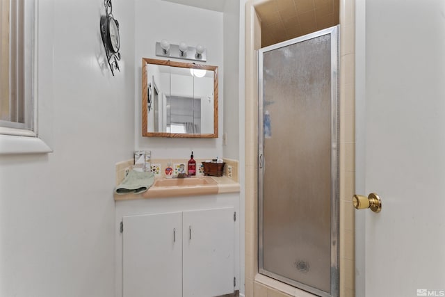 bathroom with an enclosed shower and vanity