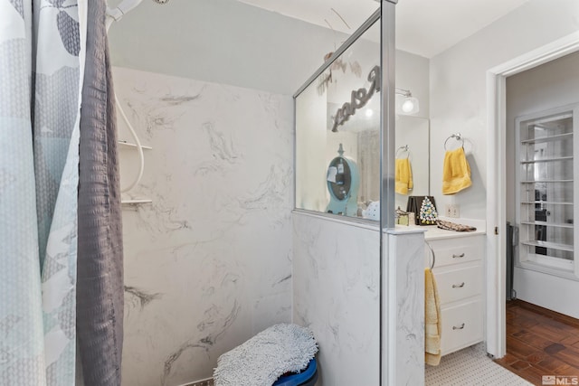 bathroom featuring vanity and a shower