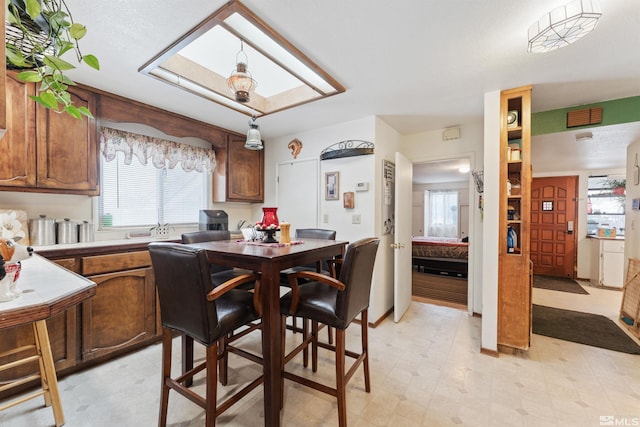 dining space featuring a skylight