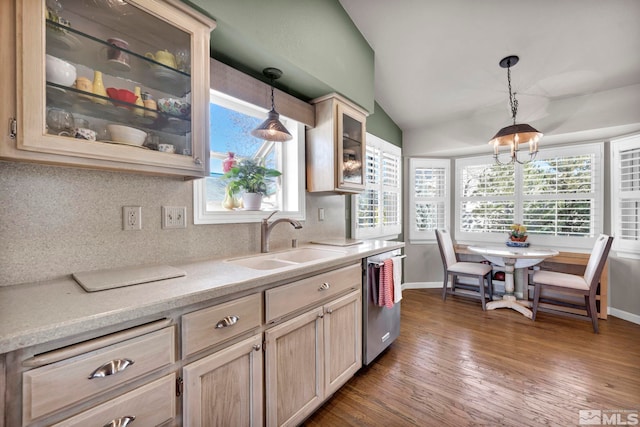 kitchen with pendant lighting, dishwasher, sink, backsplash, and light brown cabinets