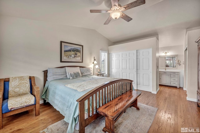 bedroom with vaulted ceiling, a closet, ceiling fan, and light hardwood / wood-style flooring