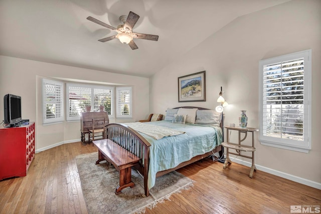 bedroom with ceiling fan, wood-type flooring, and vaulted ceiling