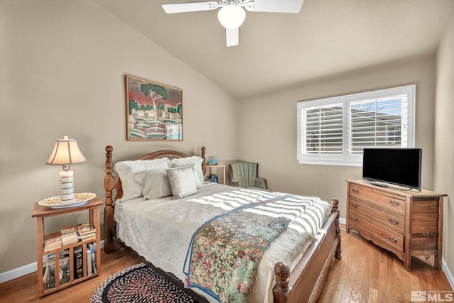 bedroom featuring vaulted ceiling, ceiling fan, and light wood-type flooring