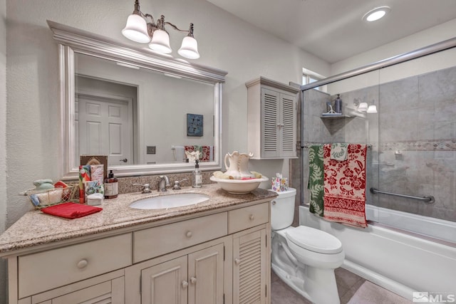 full bathroom with vanity, toilet, tile patterned flooring, and combined bath / shower with glass door