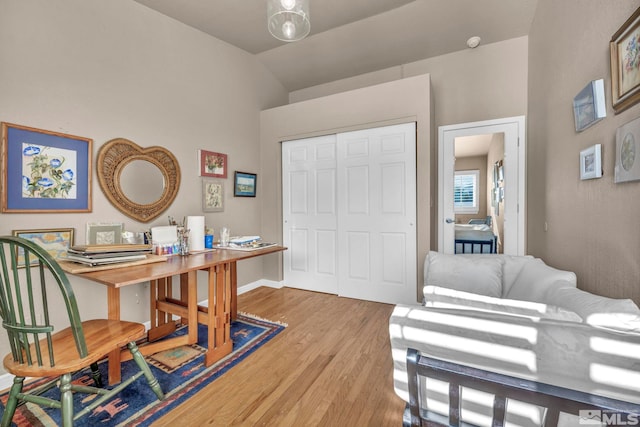 office area with vaulted ceiling and light hardwood / wood-style floors