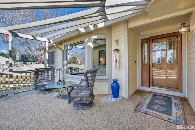 view of exterior entry featuring a pergola