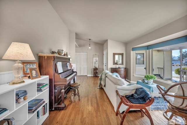 living room with vaulted ceiling and light hardwood / wood-style flooring