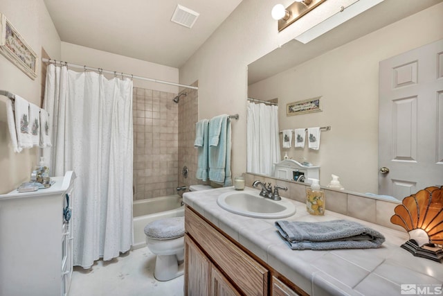 full bathroom with vanity, a skylight, toilet, and shower / bath combo with shower curtain