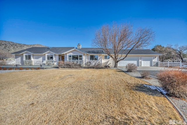 ranch-style home featuring a garage and a front yard