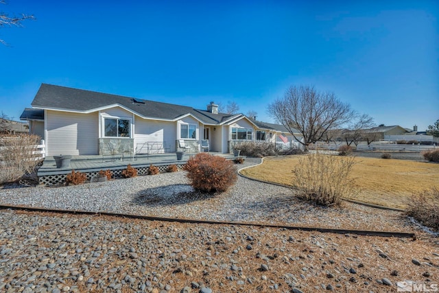 single story home with a wooden deck