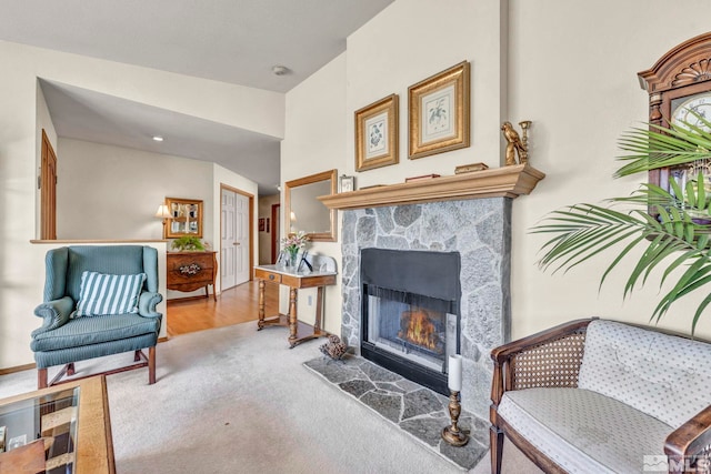 sitting room featuring light colored carpet and a fireplace