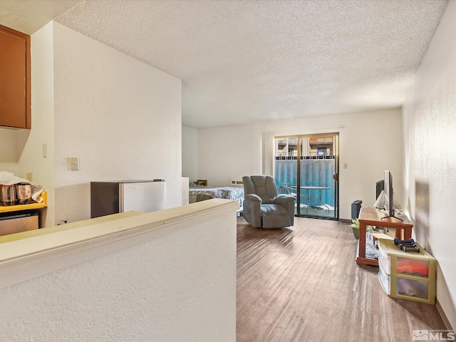 sitting room featuring hardwood / wood-style floors and a textured ceiling