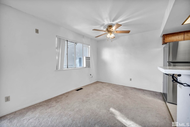 unfurnished living room with ceiling fan and light carpet