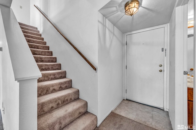 view of carpeted foyer