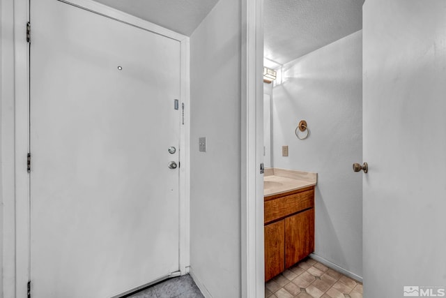 bathroom featuring vanity and a textured ceiling