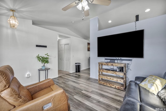 living room featuring lofted ceiling, hardwood / wood-style floors, and ceiling fan