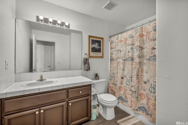 bathroom with vanity, wood-type flooring, walk in shower, and toilet