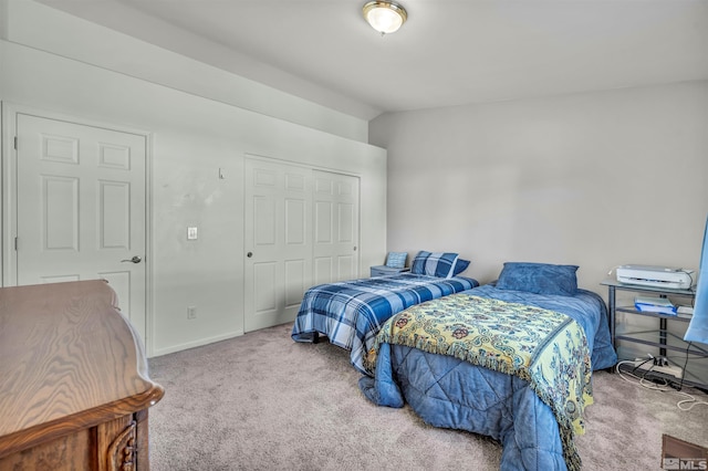 carpeted bedroom with vaulted ceiling and a closet