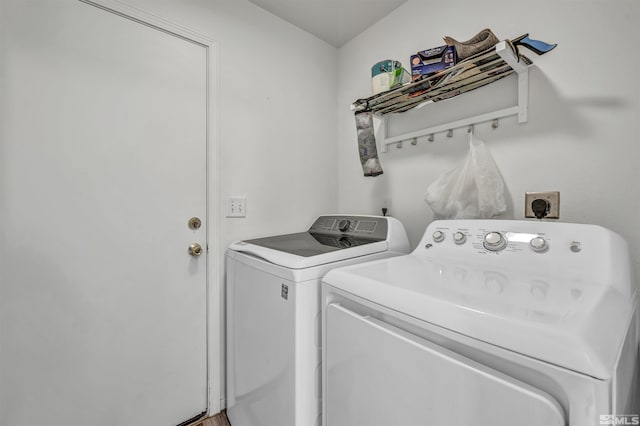 clothes washing area with washer and clothes dryer