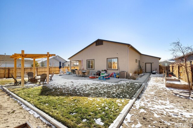 rear view of property with a patio and an outdoor fire pit