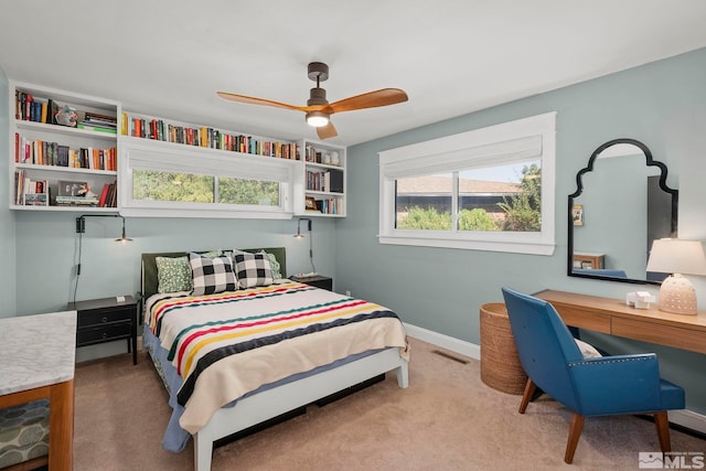 bedroom with light carpet and ceiling fan