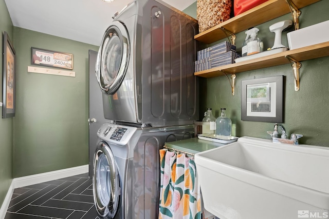 laundry room featuring stacked washer / drying machine and sink