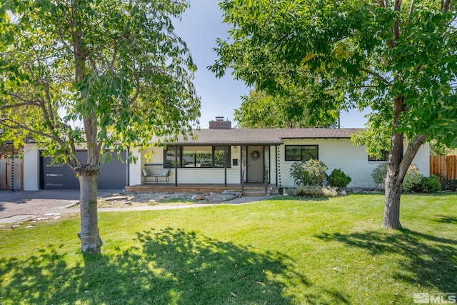 ranch-style home with a garage and a front yard