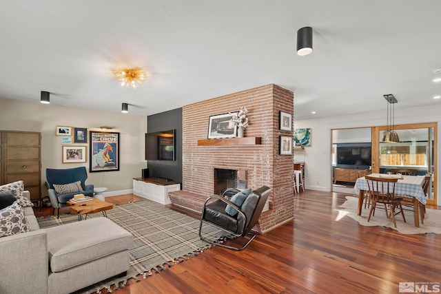 living room with a fireplace and hardwood / wood-style floors