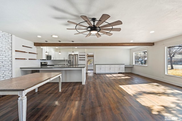 kitchen featuring white cabinetry, stainless steel appliances, decorative light fixtures, and dark hardwood / wood-style flooring