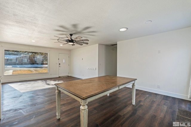 interior space with ceiling fan, dark wood-type flooring, and a textured ceiling