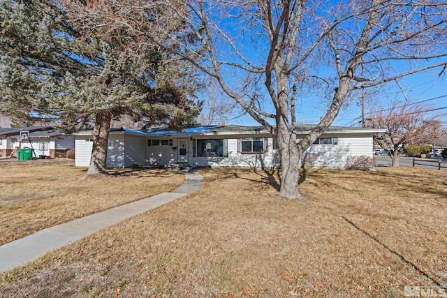 ranch-style home featuring a front yard