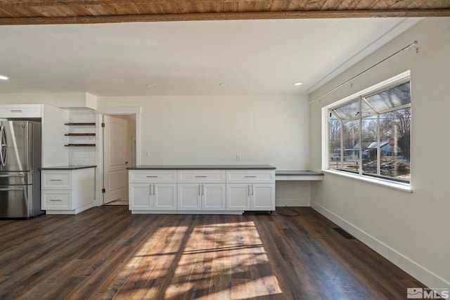 kitchen featuring white cabinetry, dark wood-type flooring, and stainless steel fridge