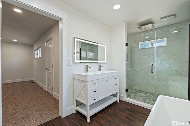 bathroom with wood-type flooring, separate shower and tub, and vanity