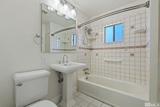 bathroom with tile patterned floors, toilet, and tiled shower / bath combo