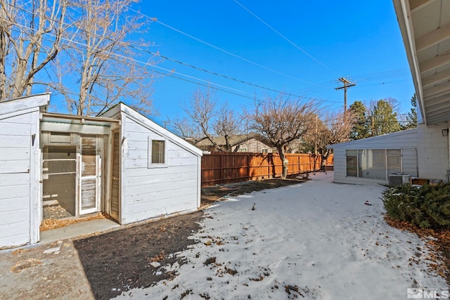 yard layered in snow with cooling unit