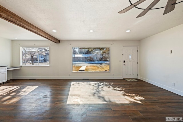 entryway with beamed ceiling, ceiling fan, a textured ceiling, and dark hardwood / wood-style flooring