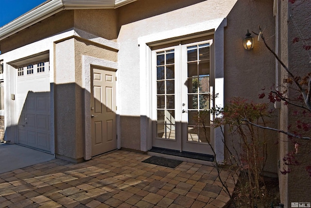 doorway to property with french doors and a garage