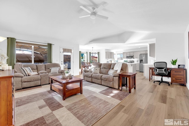 living room featuring ceiling fan, lofted ceiling, and light wood-type flooring