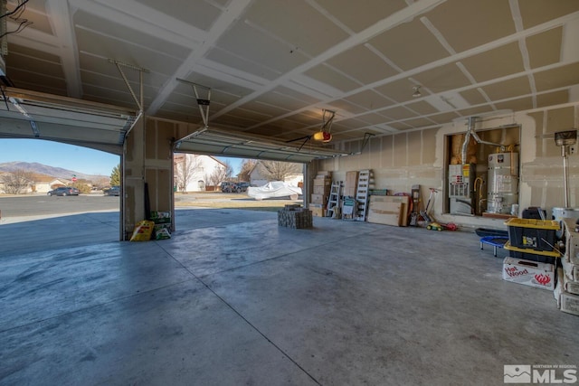 garage with strapped water heater and a mountain view