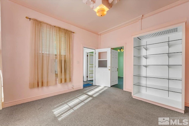 interior space featuring ornamental molding and carpet flooring