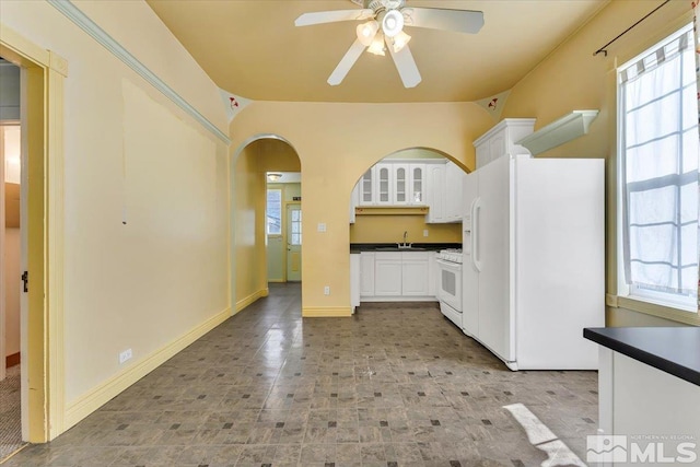 kitchen with sink, white appliances, and a wealth of natural light