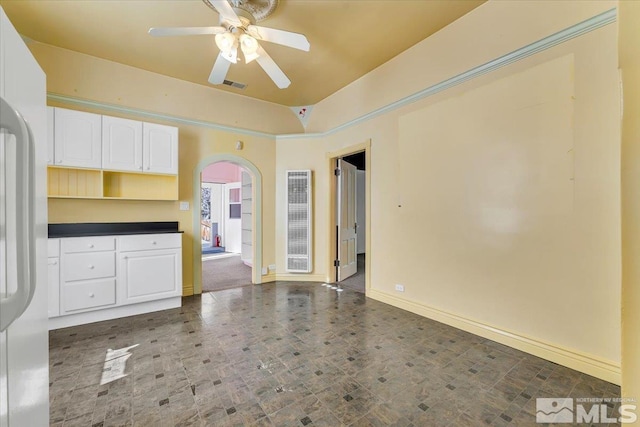 interior space with ceiling fan