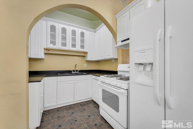 kitchen featuring sink, white cabinets, and white appliances