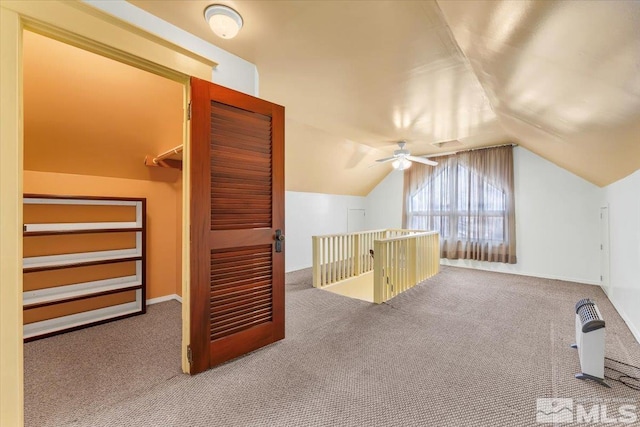 bonus room featuring vaulted ceiling and carpet