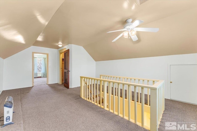 bonus room with carpet flooring and vaulted ceiling