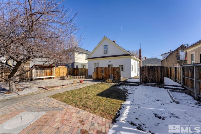 snow covered house with a patio area